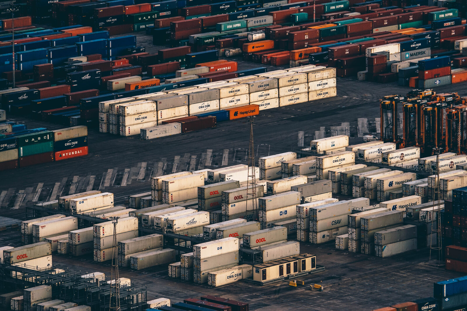 bri-belt-road-watch-june-2026 Stacked shipping containers at a container port, illustrating Belt and Road trade infrastructure