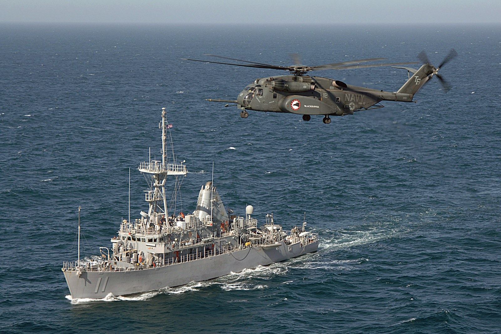 afternoon-wire-hormuz-mine-countermeasures An MH-53E Sea Dragon helicopter conducts a mine-sweeping exercise with the Avenger-class mine countermeasures ship USS Gladiator.
