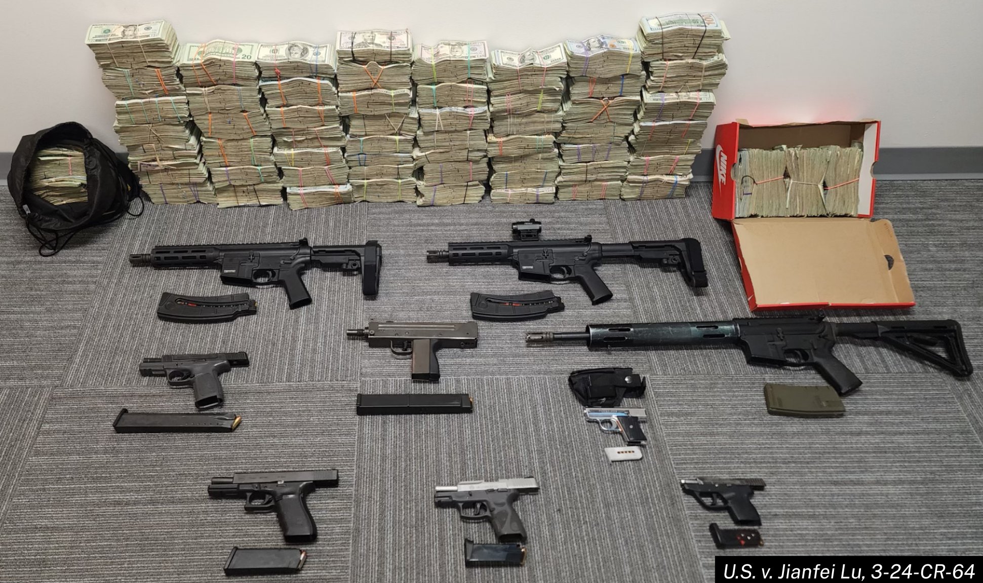 Approximately $670,000 in U.S. currency and 12 firearms seized from a drug trafficking organization that used a Chinese money laundering organization. Photo: U.S. Department of Justice (public domain).