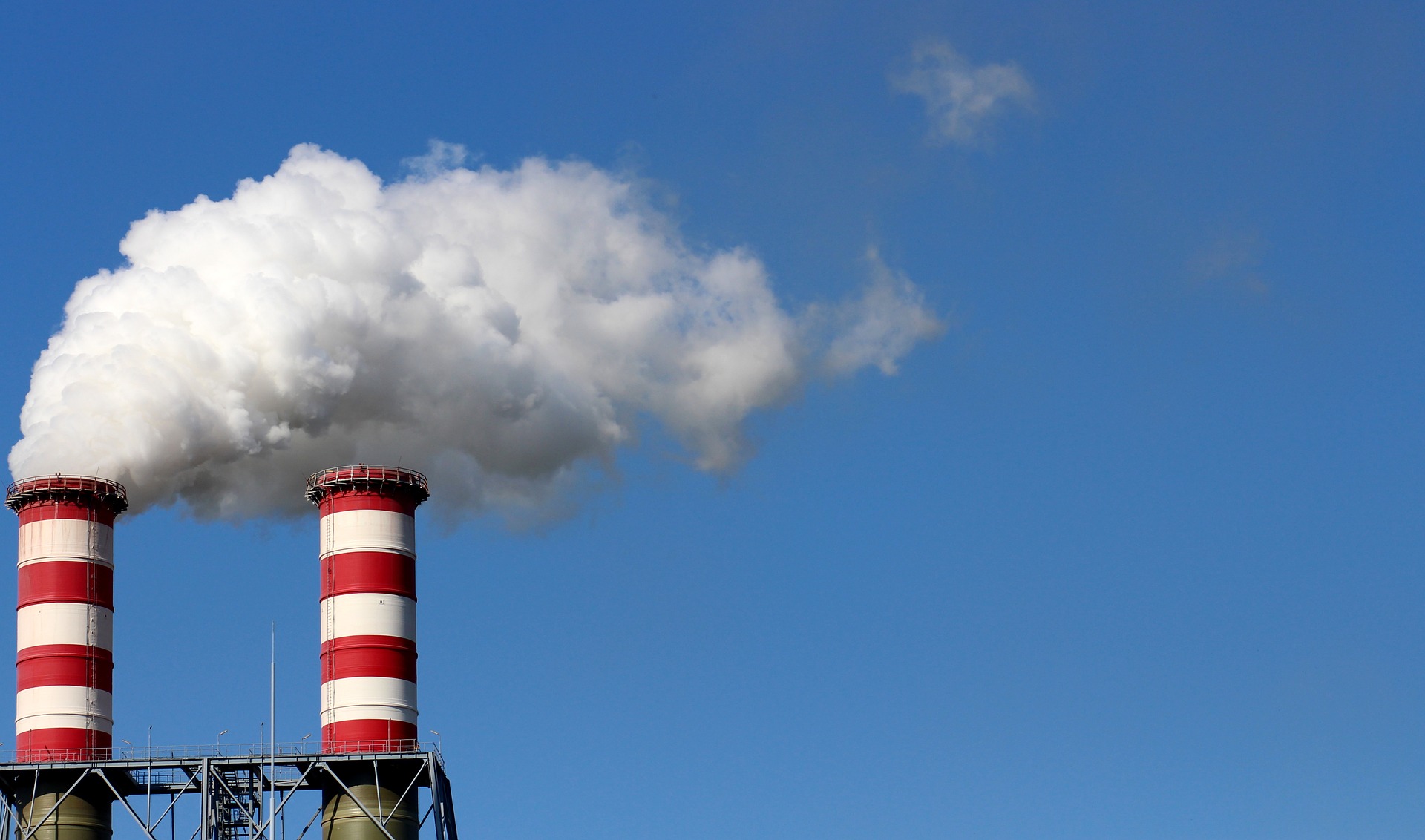 Industrial smokestacks emitting pollution, illustrating EPA air enforcement
