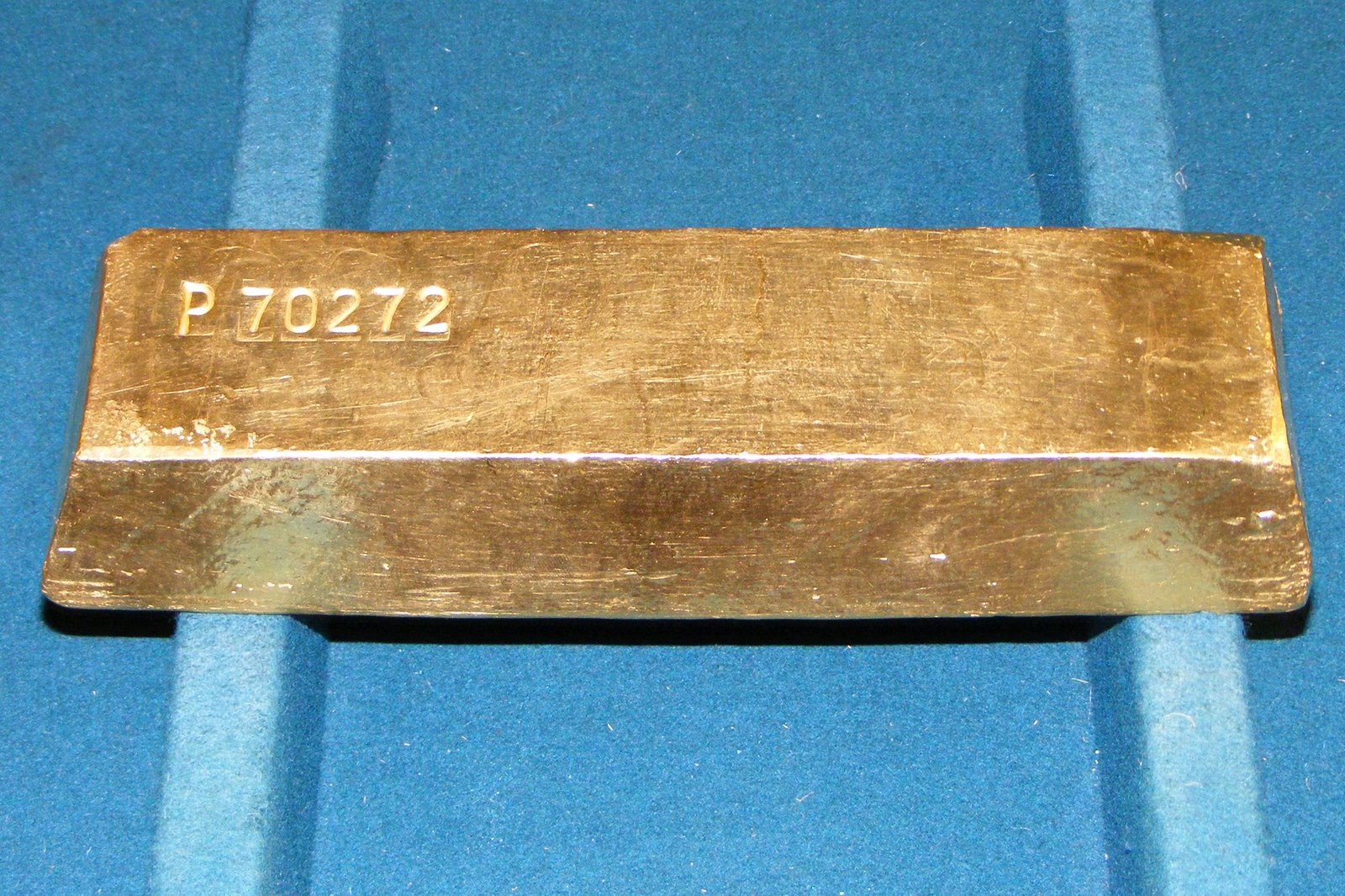 Gold bullion bars Stacked gold bullion bars, illustrating gold IRA fraud enforcement cases