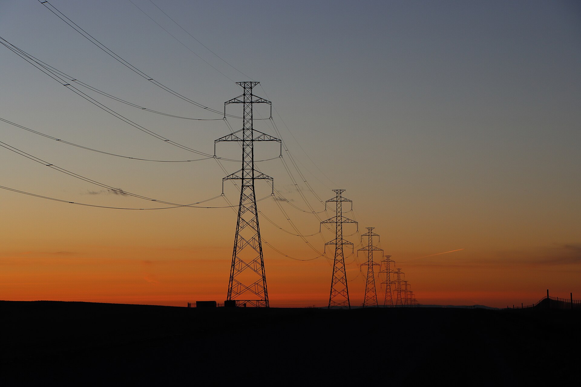 High-voltage electric transmission lines at sunset