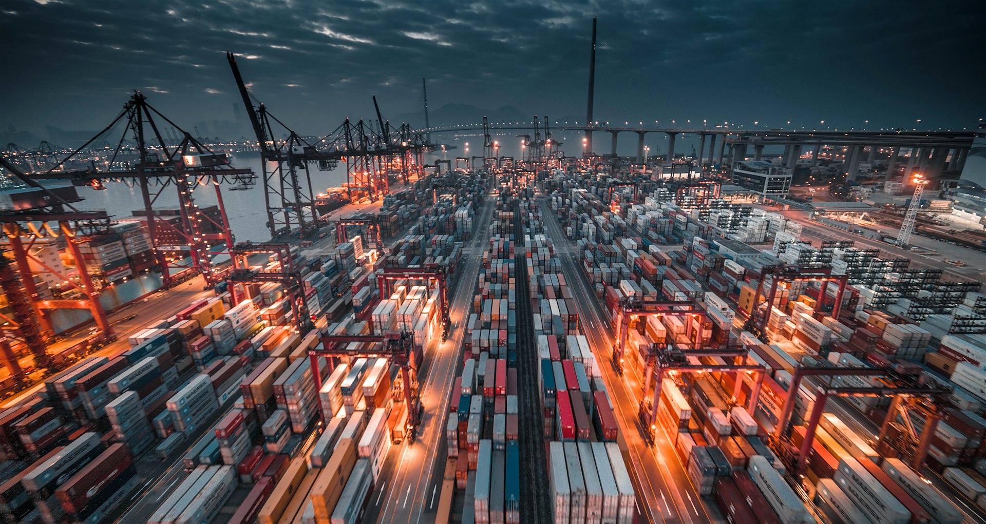 container-port-cranes Container terminal with cranes and stacked shipping containers