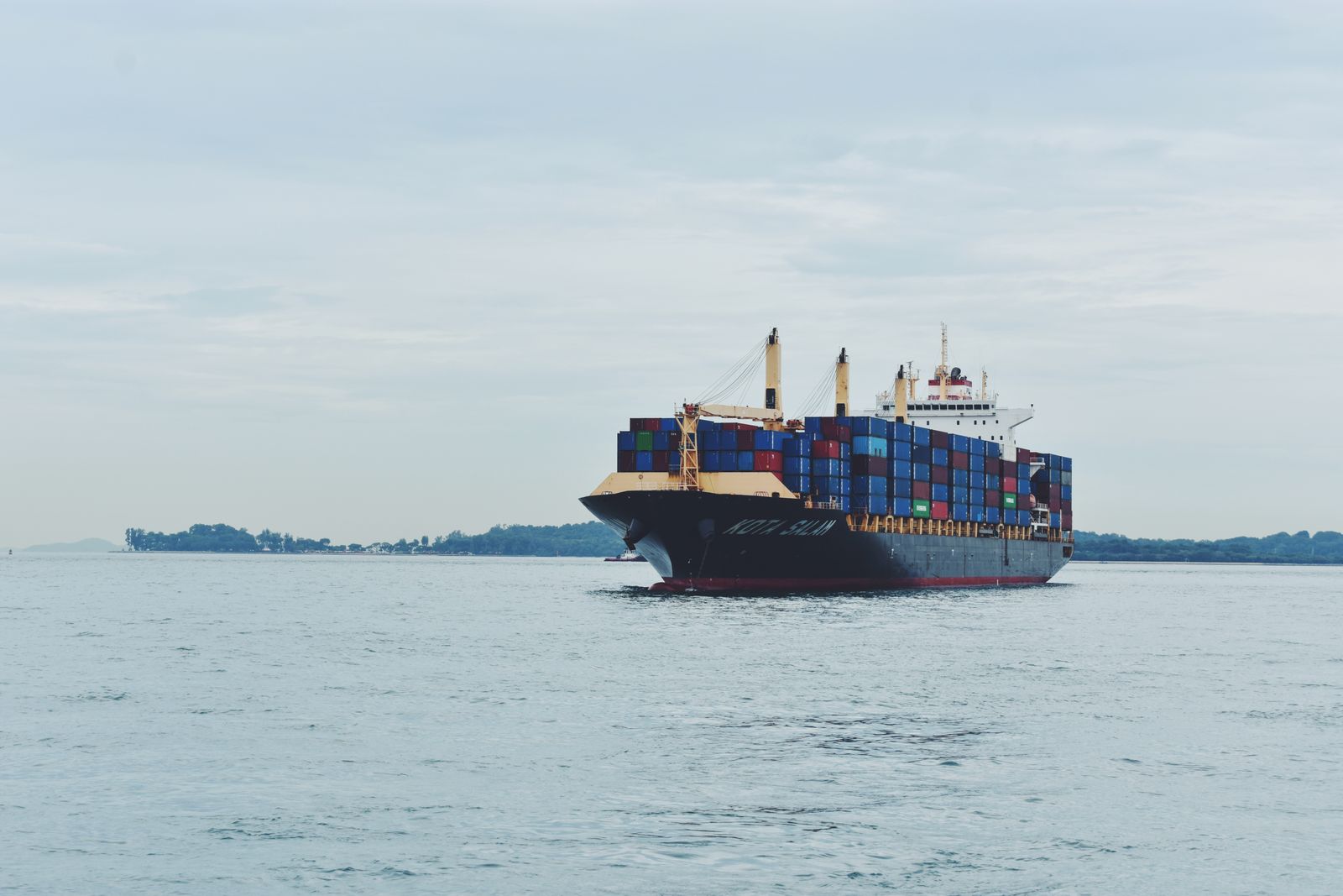 iran-shadow-fleet-law-firm-sanctions Container cargo ship at sea, stock image illustrating Iran shadow fleet sanctions